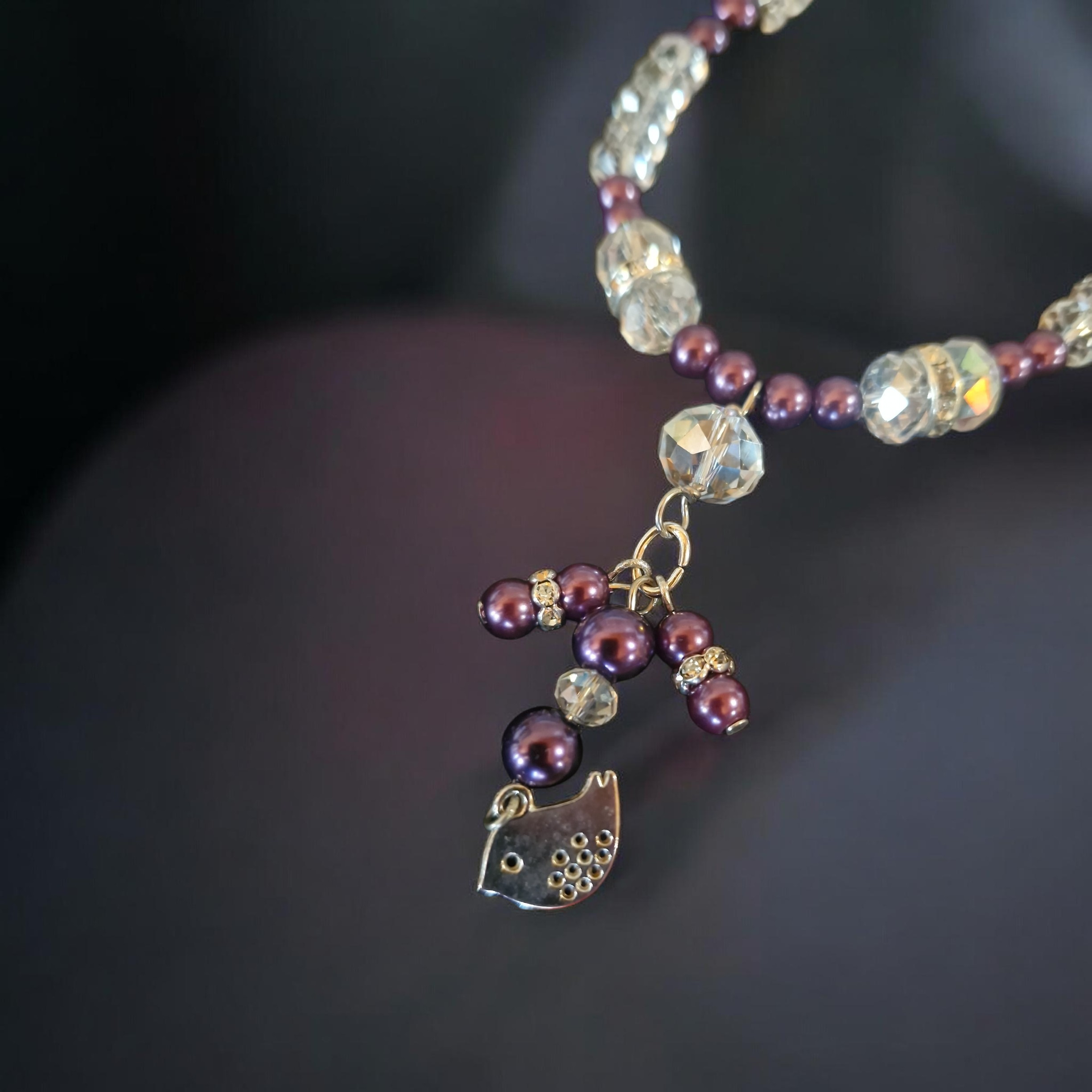 Purple glass pearls and faceted glass crystal necklace with silver bird cluster feature